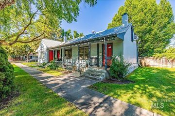 Boise apartment for rent - A house with a red door and a porch with a railing.