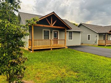 Boone house for rent - A house with a grey roof and a wooden deck.