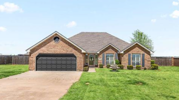 Burkburnett house for rent - A house with a garage door and a driveway.