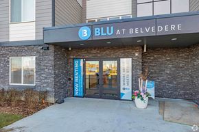 Calgary apartment for rent - The entrance to a BLU at Belvedere store with a sign that says "Now Renting".