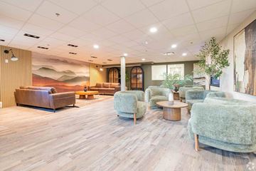 Calgary apartment for rent - A living room with a wooden floor and a large mural on the wall.