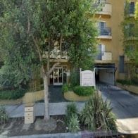 N. Hollywood apartment for rent - A tree in front of a building with a sign.