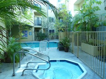N. Hollywood apartment for rent - A small pool surrounded by a metal fence and a chair.