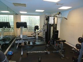 N. Hollywood apartment for rent - A gym with a variety of equipment including a treadmill, weights, and a bench press.