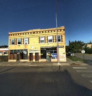 Chicago apartment for rent - A yellow building with a closed bank and a closed business in front of it.