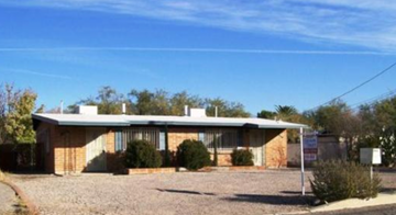 Tucson house for rent - A house with a gravel driveway in front.