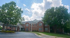 Raleigh apartment for rent - A large building with a parking lot in front.