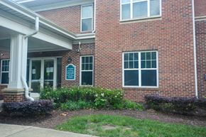 Raleigh apartment for rent - A brick building with a sign on the front.