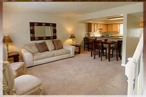 Raleigh apartment for rent - A living room with a couch, chair, and a mirror on the wall.