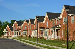 Raleigh apartment for rent - A row of red brick houses with white trim and black roofs.