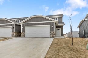Sioux Falls house for rent - A house with a grey garage door is shown in the image.