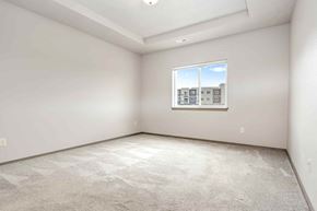 Sioux Falls house for rent - A room with a carpeted floor and a window showing a building outside.