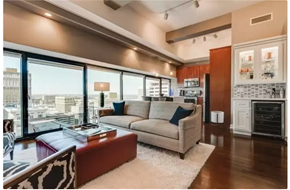 Kansas City apartment for rent - A modern living room with a large window overlooking the city.