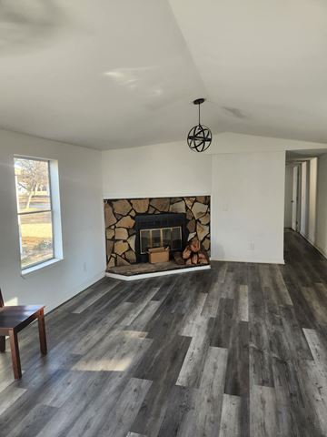 Watkinsville apartment for rent - A room with a fireplace and wood flooring.