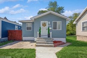 Gary house for rent - A blue house with a white door and a garage door opener.