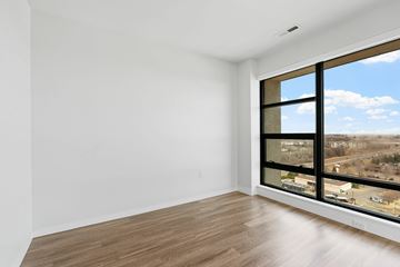 Eagan apartment for rent - A living room with a grey couch, a white chair and a white sofa.