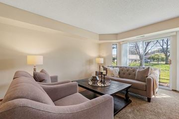 Woodbury apartment for rent - A living room with a grey couch and a coffee table.