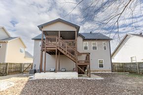 Clarksville house for rent - A house with a deck and stairs leading to the entrance.