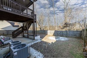 Clarksville house for rent - A backyard with a deck and a hot tub.