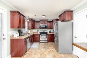 Clarksville house for rent - A kitchen with wooden cabinets and a tile floor.