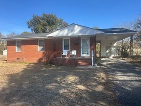 Fayetteville house for rent - A red brick house with a white door and windows.
