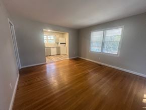 Fayetteville house for rent - A room with wooden flooring and two windows.