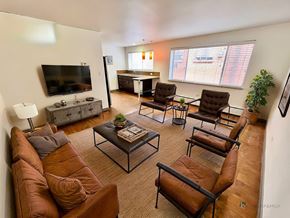Denver apartment for rent - A red brick building with the number 65 on it.