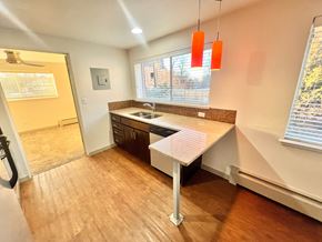 Denver apartment for rent - A staircase with a tiled floor and a wooden handrail.