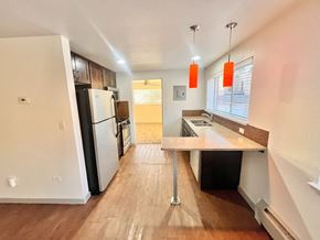 Denver apartment for rent - A staircase with a black railing and a brown carpeted runner.