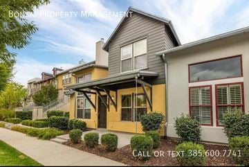 South Jordan house for rent - A row of houses with a sign that says "BONS PROPERTY MANAGEMENT" and a phone number.