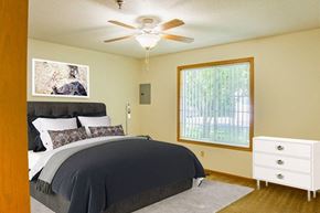 White Bear Lake apartment for rent - A bedroom with a bed, dresser, and window.