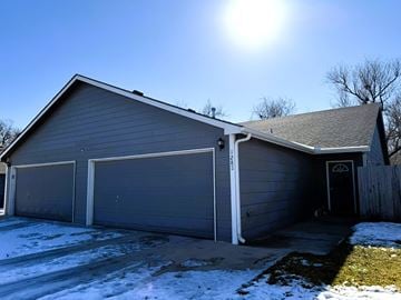 Wichita house for rent - A house with a grey garage door and a black door.