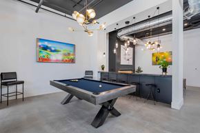 Lewis Center apartment for rent - A pool table is in the middle of a room with a chair and a painting on the wall.