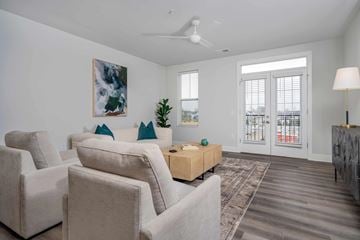 Lewis Center apartment for rent - A living room with a large painting on the wall and a ceiling fan.