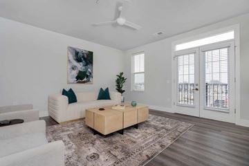 Lewis Center apartment for rent - A living room with a white couch, a wooden coffee table, and a painting on the wall.