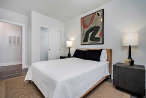 Lewis Center apartment for rent - A bedroom with a large bed and a painting on the wall.