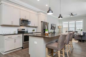 Lewis Center apartment for rent - A kitchen with a bar area and a dining table.