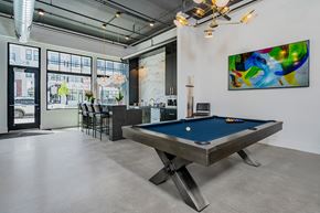 Lewis Center apartment for rent - A pool table is in the middle of a room with a painting on the wall.
