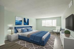 Lakewood apartment for rent - A bedroom with a large bed and a painting on the wall.