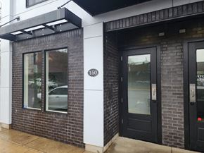Monmouth apartment for rent - A building with a black door and a window with a reflection of a car.