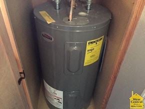 Clinton house for rent - A grey Energis gas heater in a wooden cabinet.