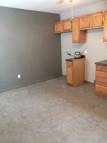 Clinton house for rent - A kitchen with wooden cabinets and a tiled floor.