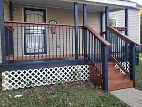 Clinton house for rent - A house numbered 205 has a black railing on its porch.