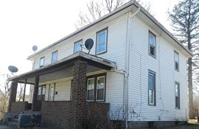 Akron apartment for rent - A white house with a satellite dish on the roof.