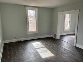Akron apartment for rent - A room with a grey wall and a window with a white frame.