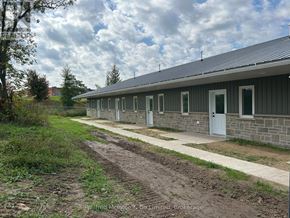 Arran-Elderslie townhouse for rent - A row of houses with white doors and windows.