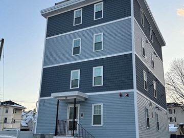 Worcester apartment for rent - A tall building with a blue and white exterior.
