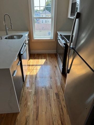 Worcester apartment for rent - A kitchen with a refrigerator, sink, and window.