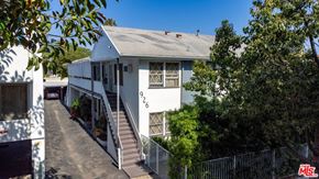 West Hollywood apartment for rent - A white house with a staircase leading to the front door.