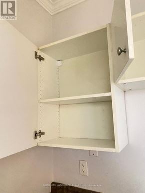Barrie (City Centre) multi-family for rent - A white cabinet with an open drawer and a closed cabinet above it.
